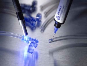 Adhesives, protective materials and processing equipment for medical device assembly
